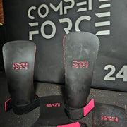 A pair of Panther Fingerless Grips featuring sleek black design with Panther Grip technology. The grips are made from chalk-free materials for enhanced control and comfort during workouts. They have a 2.9mm thickness and 2.5cm strap for a secure fit, providing unrestricted mobility for movements like Muscle Ups, Kipping Pulls, and TTB. Available in five sizes (XS, S, M, L, XL) to ensure a perfect fit for maximum performance. Ideal for athletes seeking top-notch support and comfort during intense training.